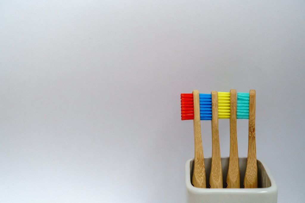 4 multicolored bamboo toothbrushes. Meant to display my discussion of habit stacking and dental hygiene. Read below. 